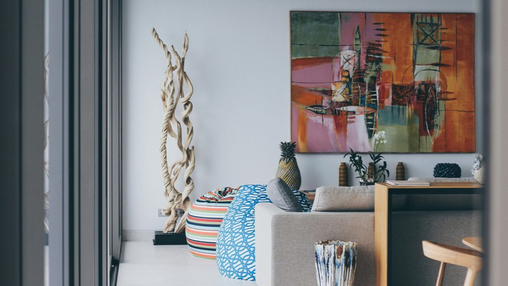 a living room with a painting on the wall