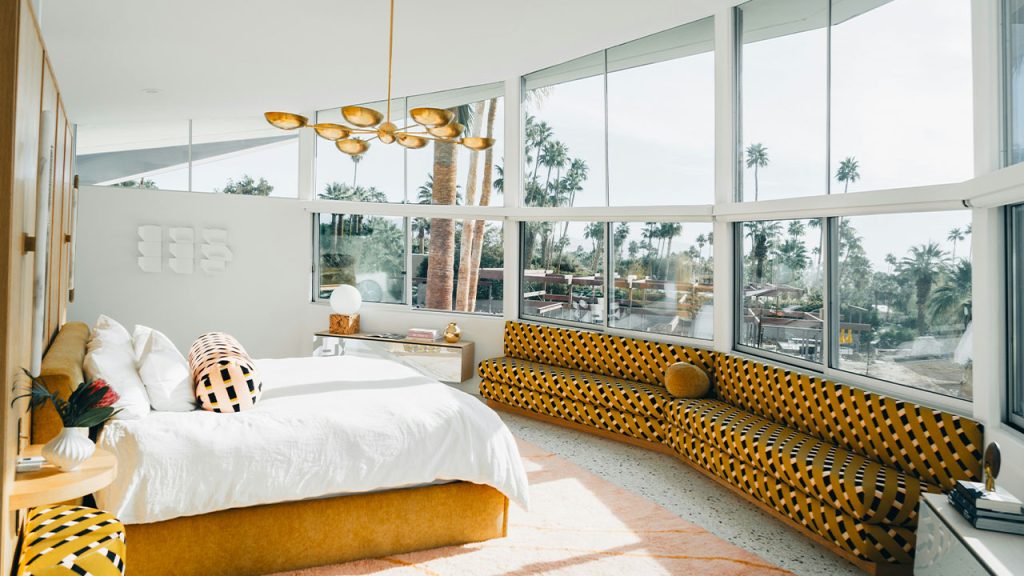 a bedroom with a large bed and a large window