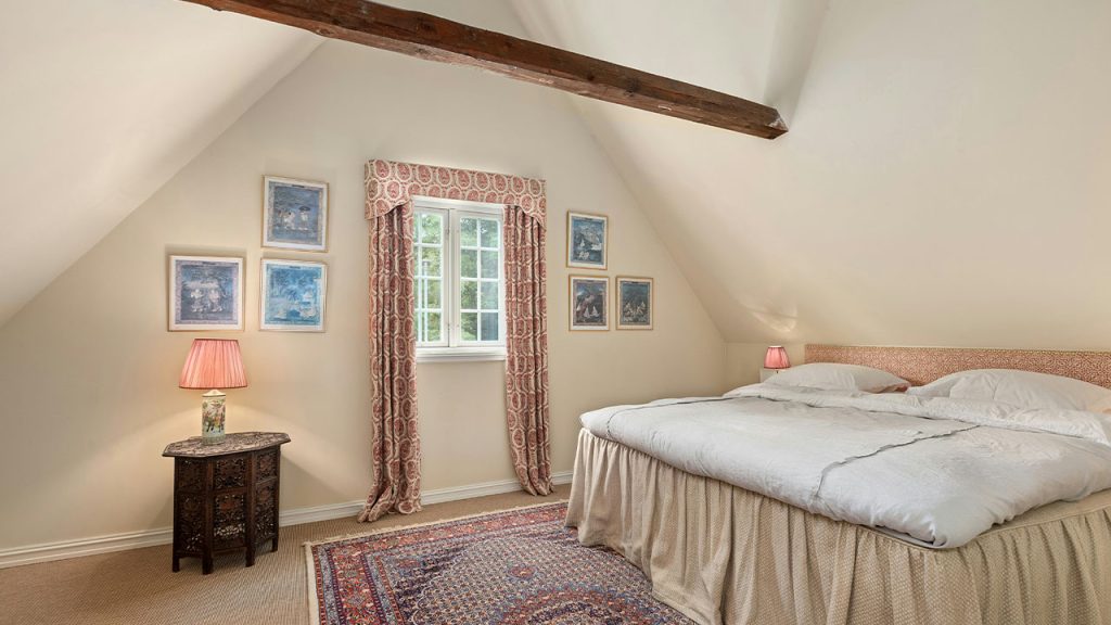 A bedroom with a bed and a rug in it
