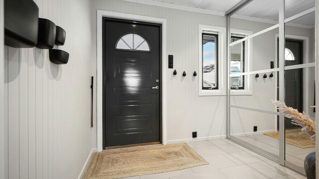 A room with a black door and white walls