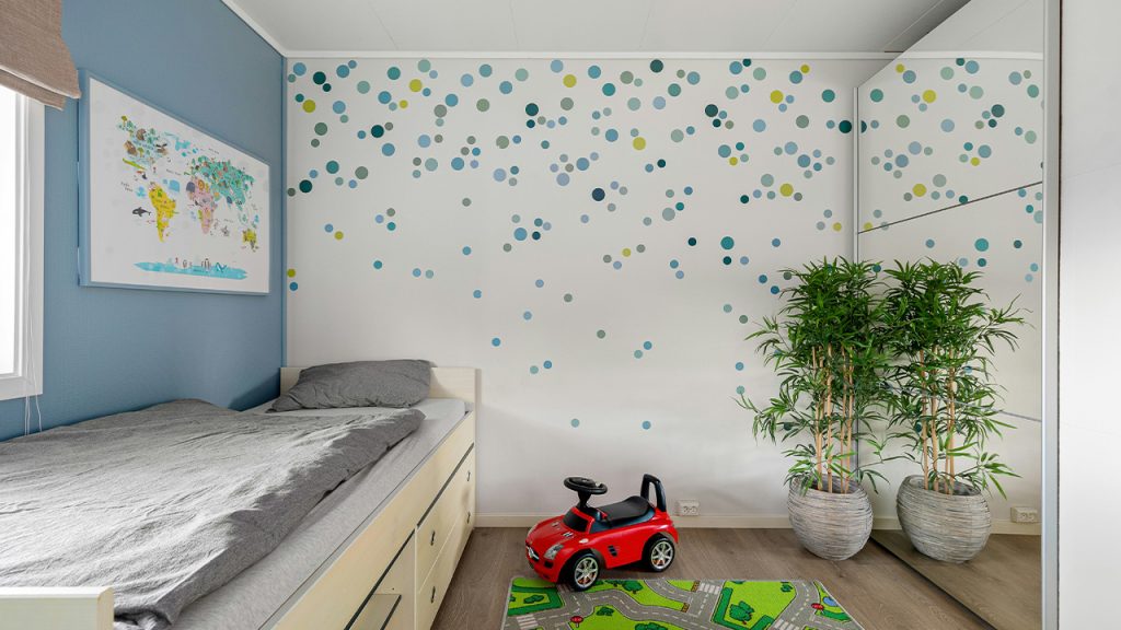 A child's bedroom with a toy car on the floor