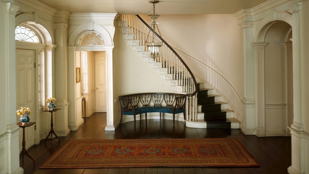 a staircase in a house with a rug on the floor