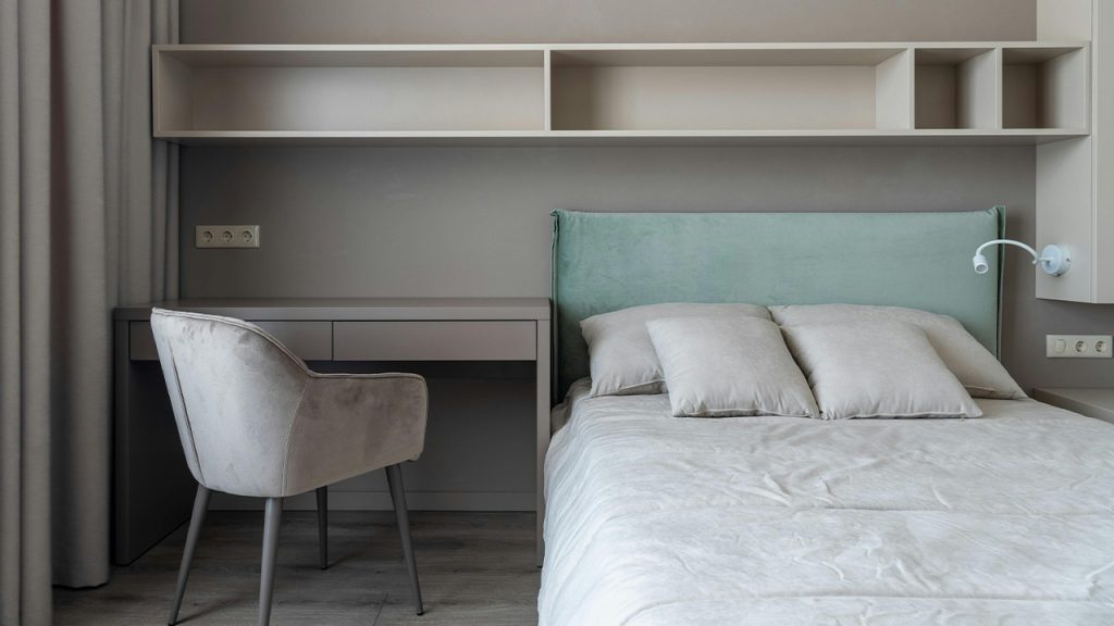 Apartment interior with bed near table with chair