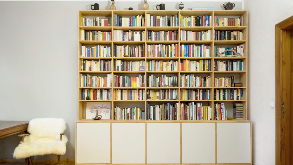 books on white wooden shelf