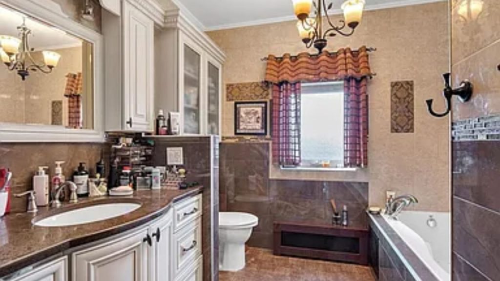 Elegant bathroom with a double vanity, soaking tub, and warm-toned décor.