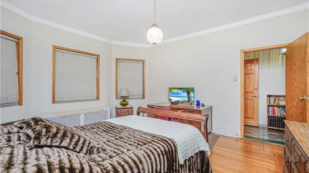 Bedroom with a plush bed, wooden furniture, and soft lighting.
