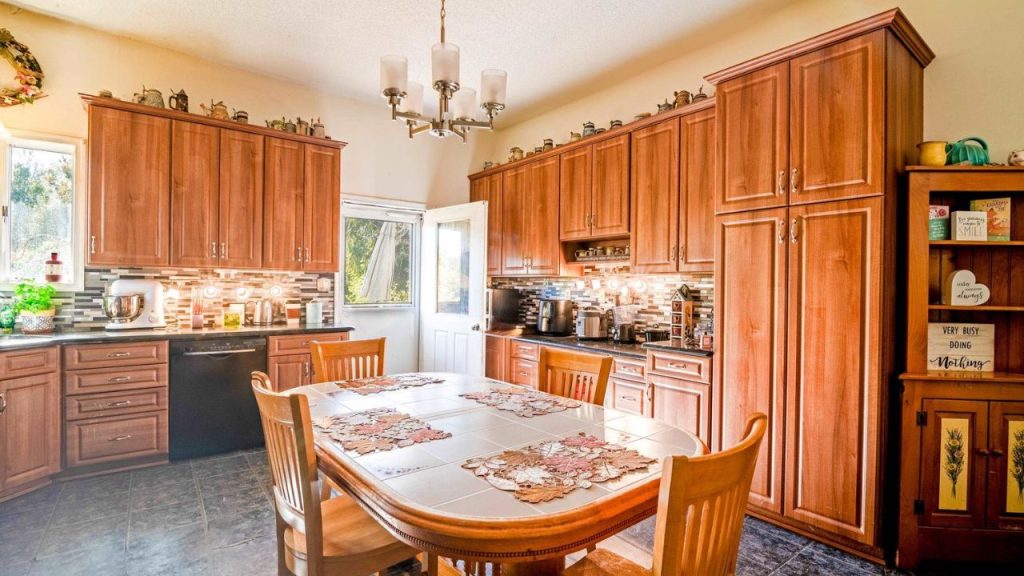 Bright kitchen with wooden cabinets, a cozy dining area, and warm decor.