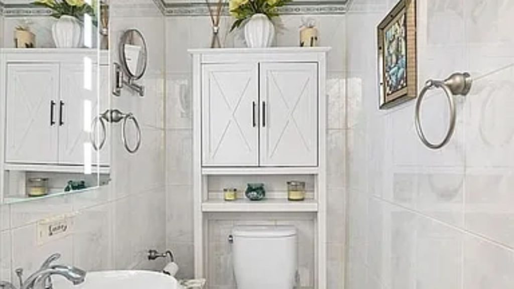 Bright bathroom with white cabinetry, tiled walls, and elegant décor.