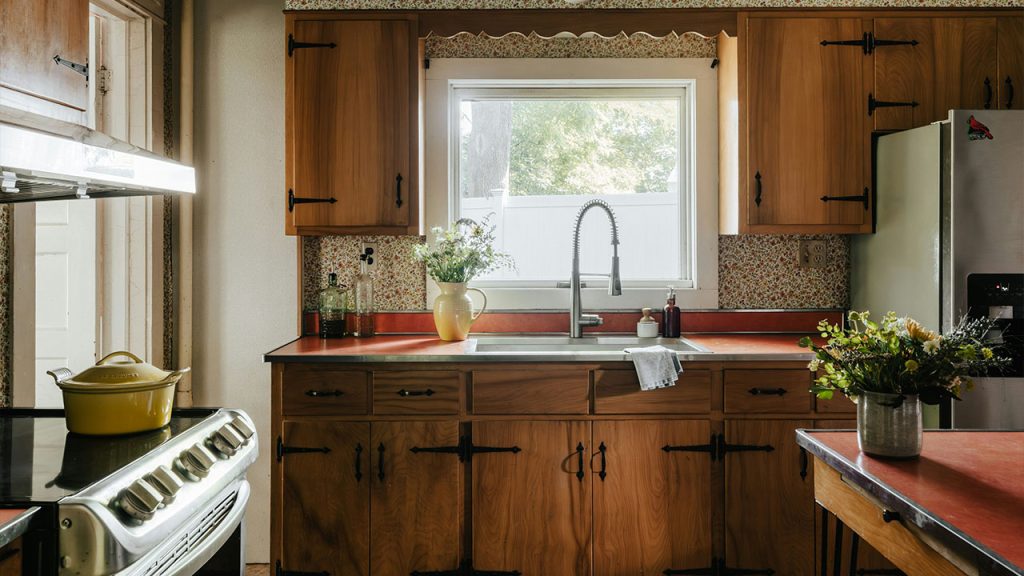 A kitchen with wooden cabinets and a stove top oven