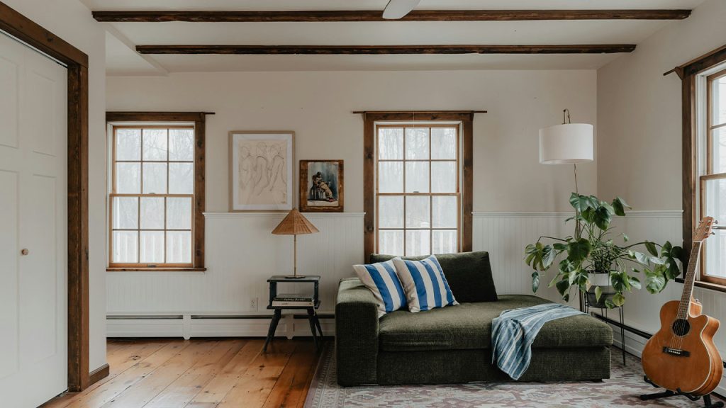 a living room with a couch and a guitar