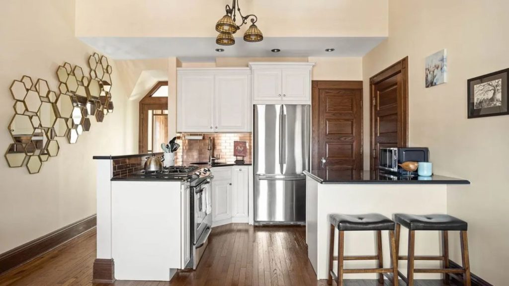 Cozy kitchen with white cabinets, stainless-steel appliances, and a breakfast bar.