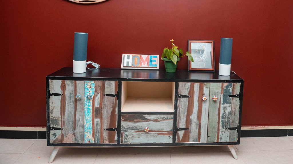 a sideboard with a mirror and a vase on top of it