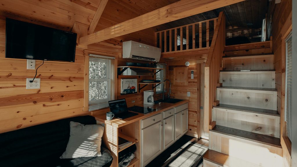 black flat screen tv on brown wooden tv rack
