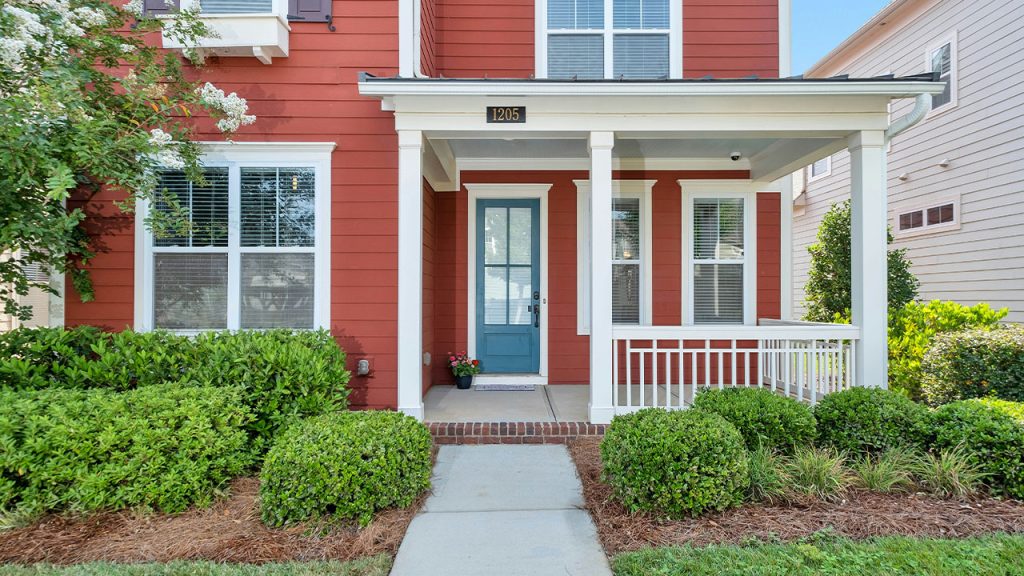red and white house with green grass lawn