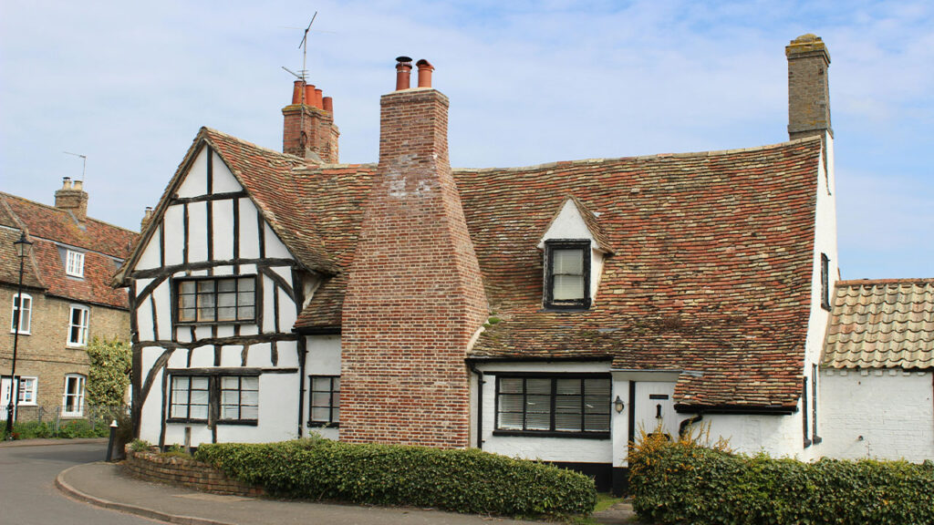 a white and black house with a red roof