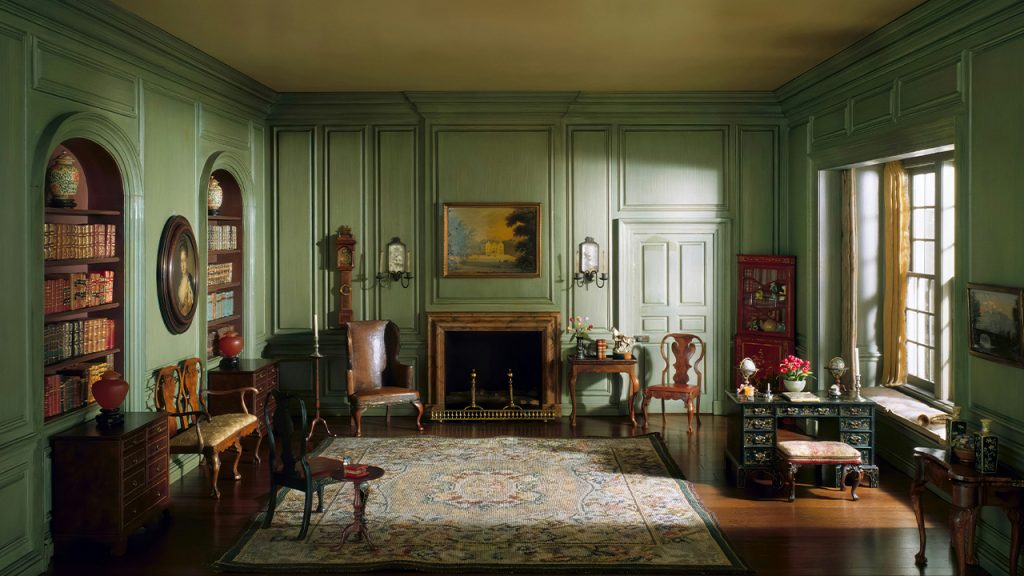 a room with green walls and a rug on the floor