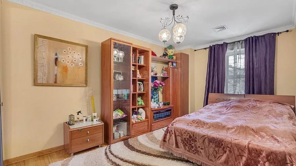 Cozy bedroom with warm tones, wooden furniture, and a personal touch.