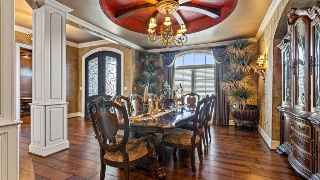 Elegant dining room with carved wooden furniture and decorative ceiling.