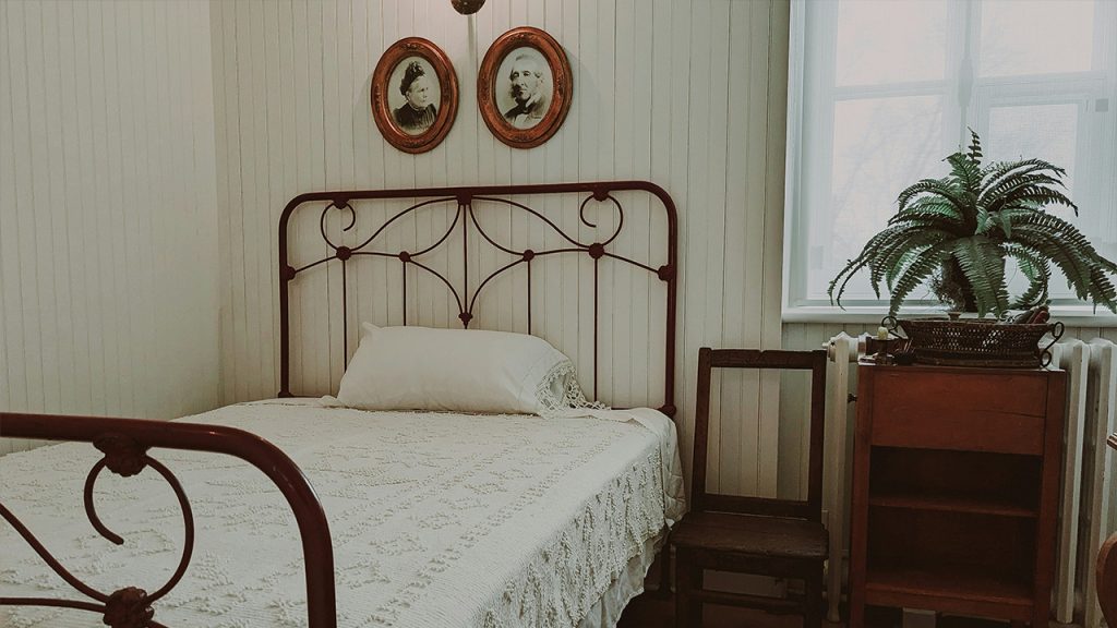 a bed with a white bedspread in a room