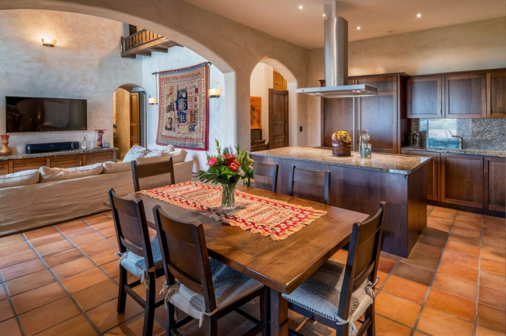 The interior of a Spanish-style home showing the living, dining and kitchen.