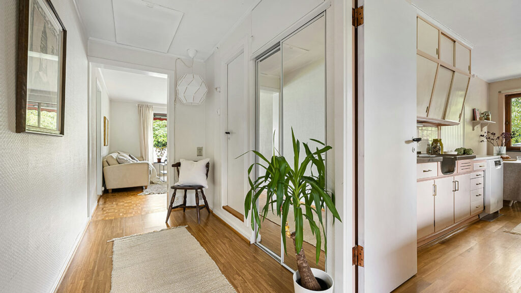 A living room with hardwood floors and white walls