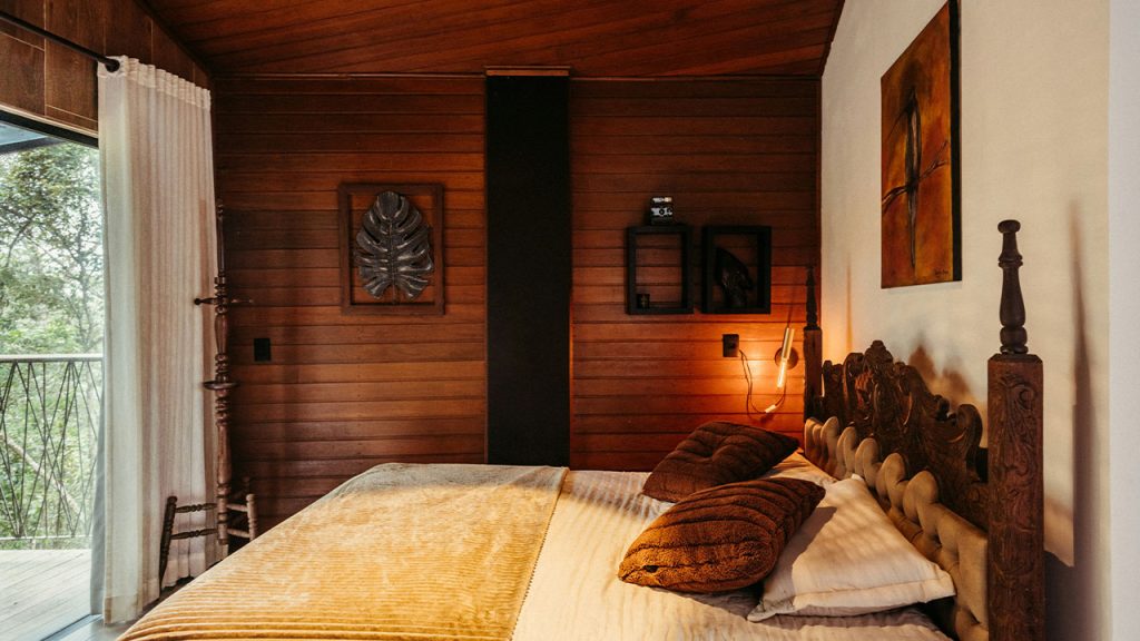 A bedroom with a large bed and wooden walls