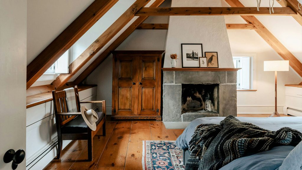 A bedroom with a bed and a fireplace in it