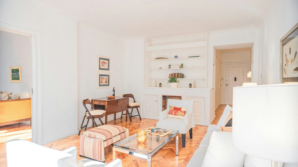 a living room filled with furniture and a fire place