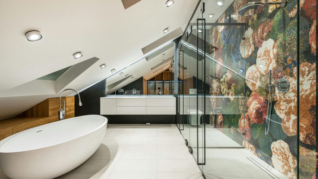 White Ceramic Bathtub With Stainless Steel Faucet Near the Glass Panel Wall