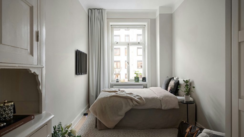 A bedroom with two beds and a dresser