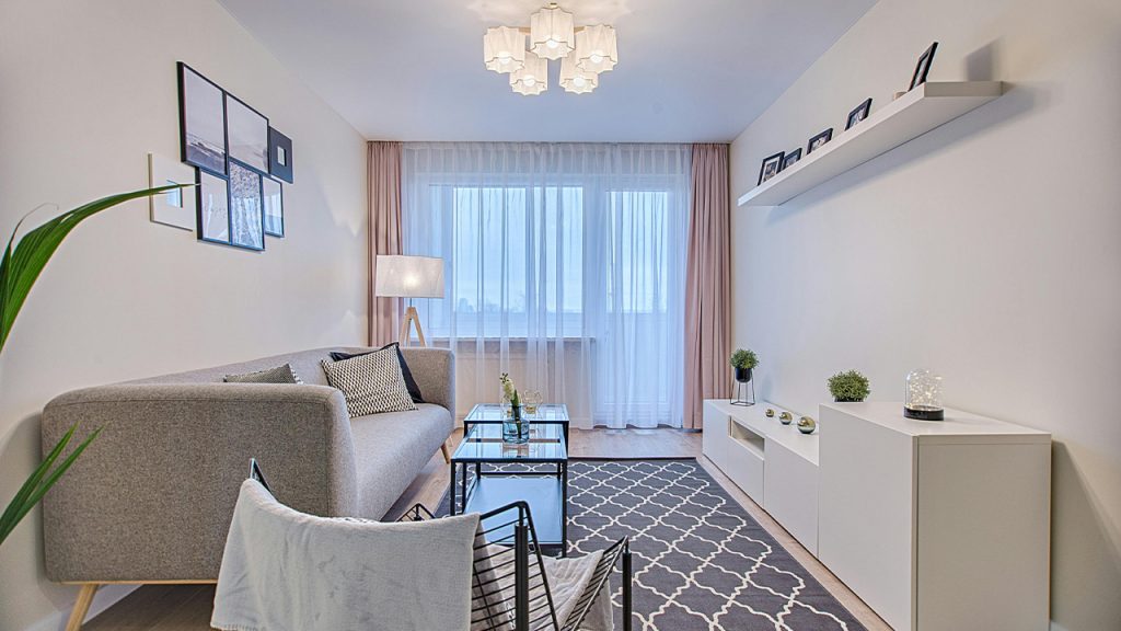 Gray Fabric Padded Sofa and Glass-top Coffee Table Inside Living Room