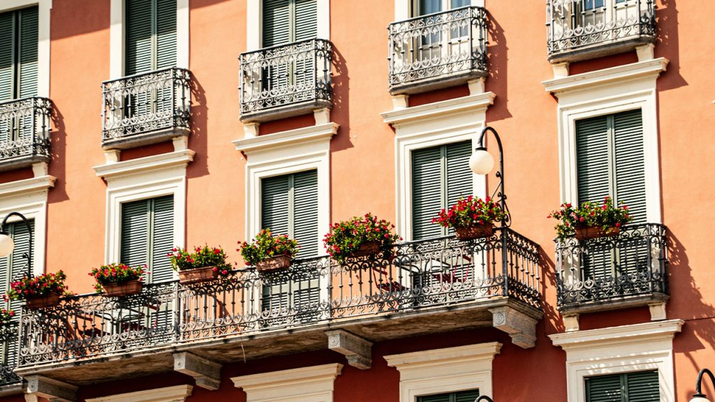 a building with a bunch of flowers on the balconies