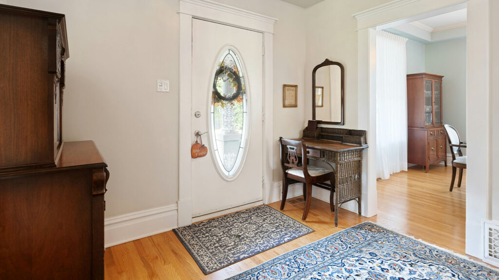 a living room with a piano and a mirror
