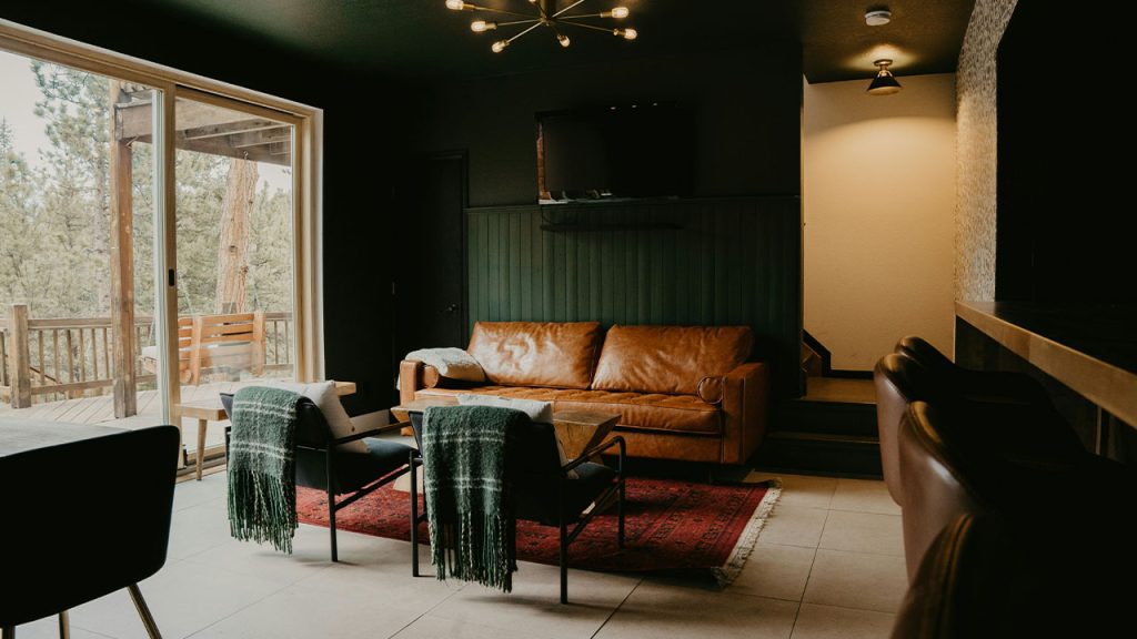 a living room filled with furniture and a sliding glass door