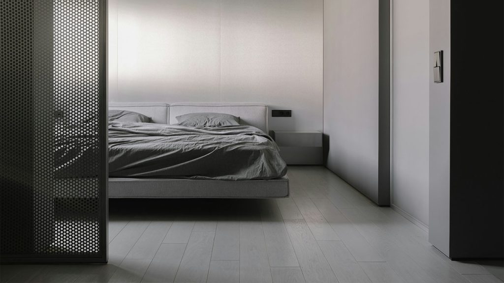 A bed sitting in a bedroom next to a closet