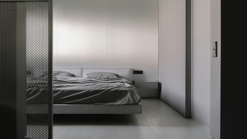 A bed sitting in a bedroom next to a closet