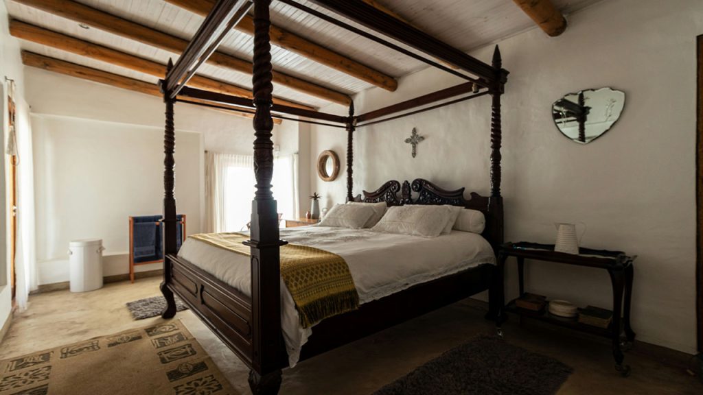 
A bed sitting in a bedroom next to a window