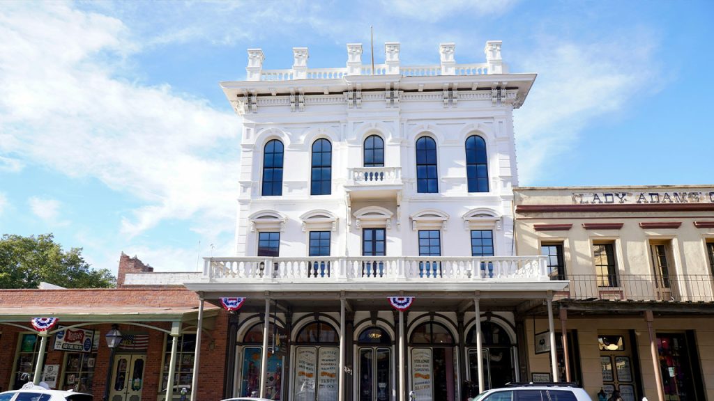 a white building with cars parked in front of it