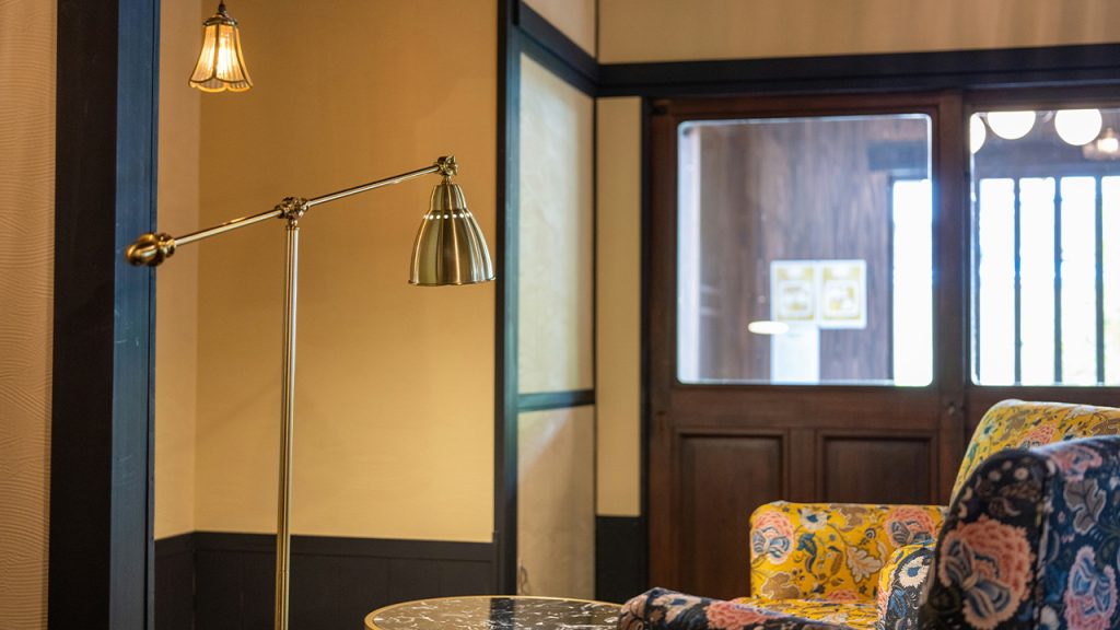 a living room with a lamp and a couch