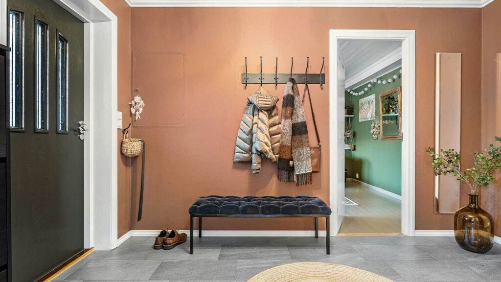 A room with a bench and a painting on the wall