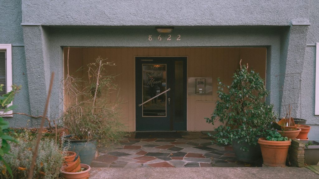 a building with potted plants in front of it