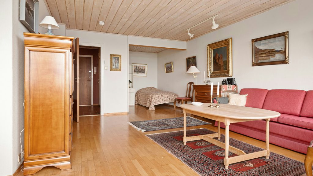 A living room filled with furniture and a wooden floor