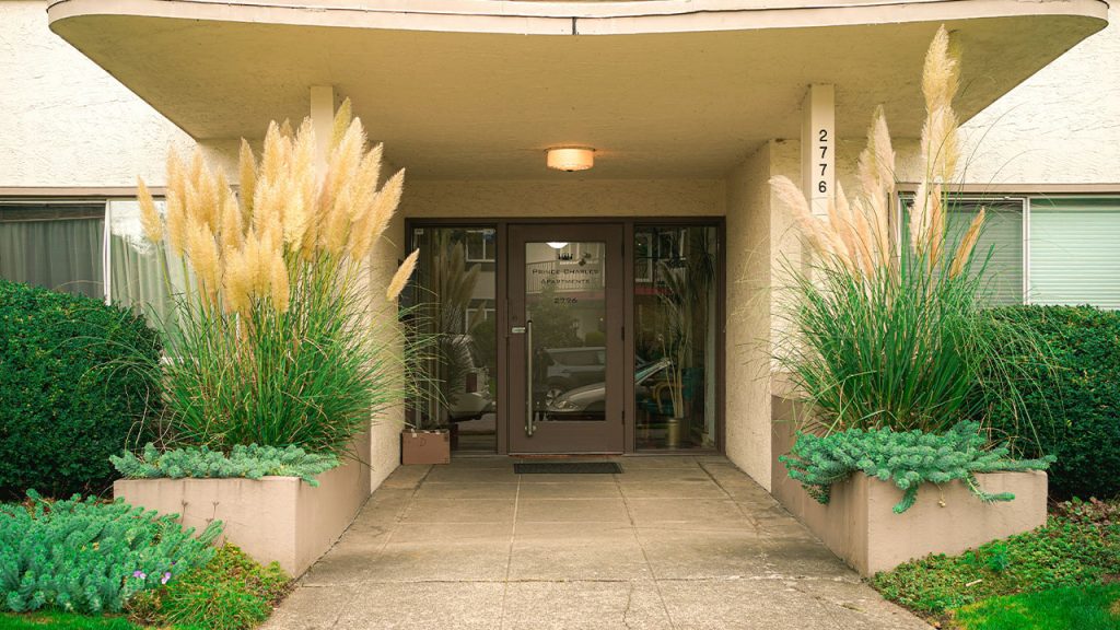A very nice looking building with some plants in front of it
