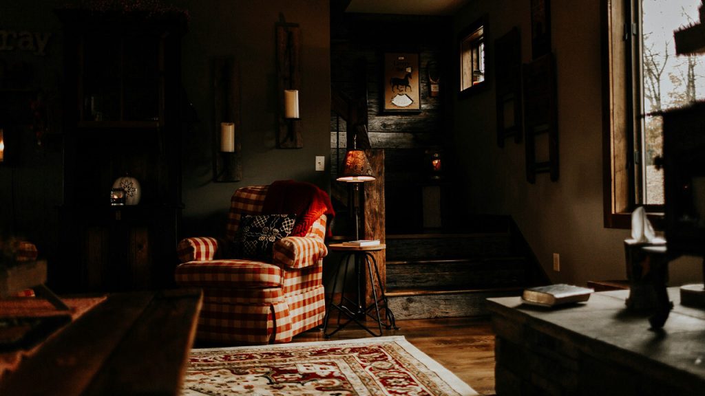 red and white checkered armchair beside rack