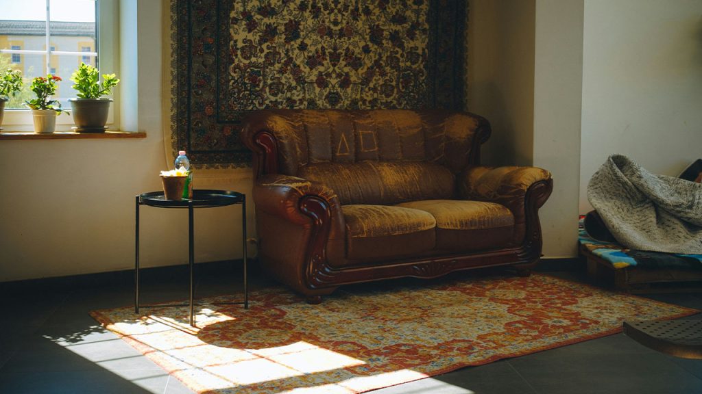 a living room with a couch and a rug