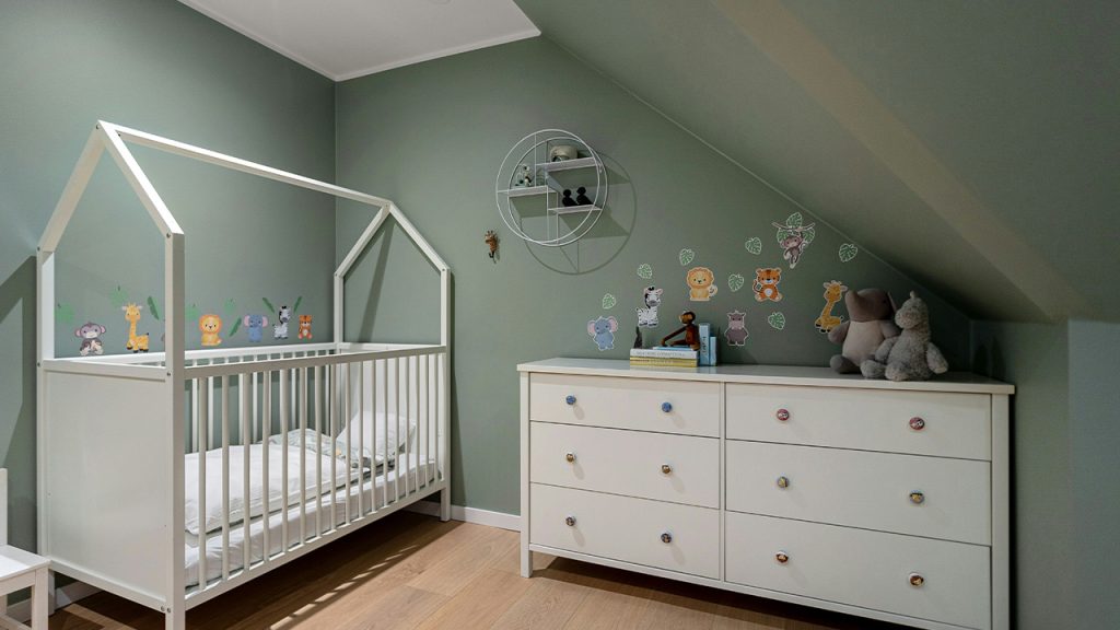 A baby's room with a crib and dresser