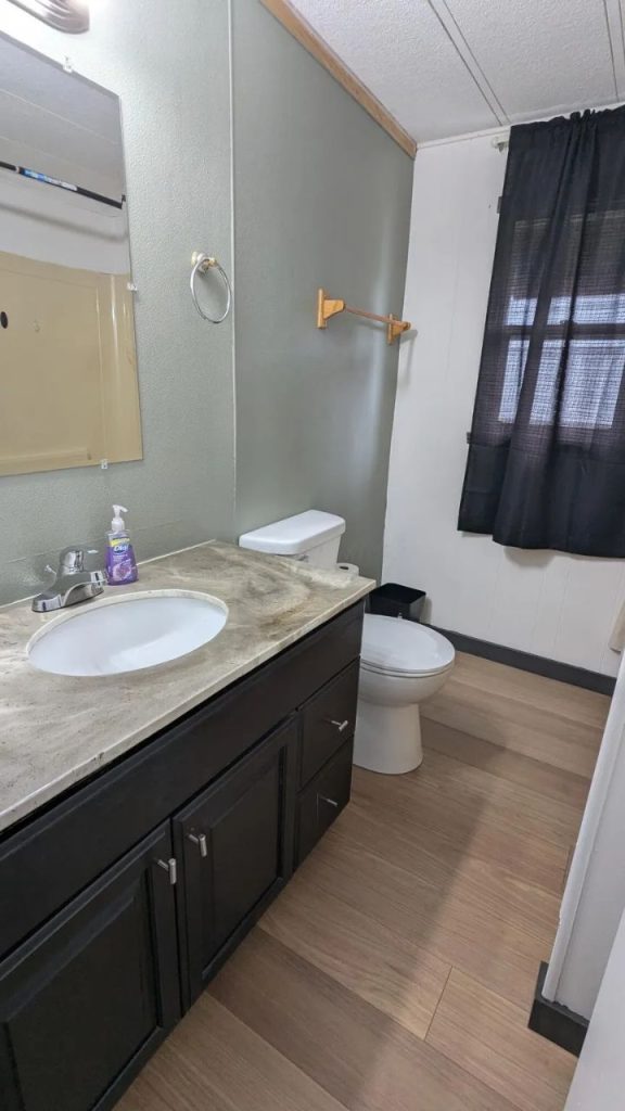 Stylish Bathroom With Dark Vanity