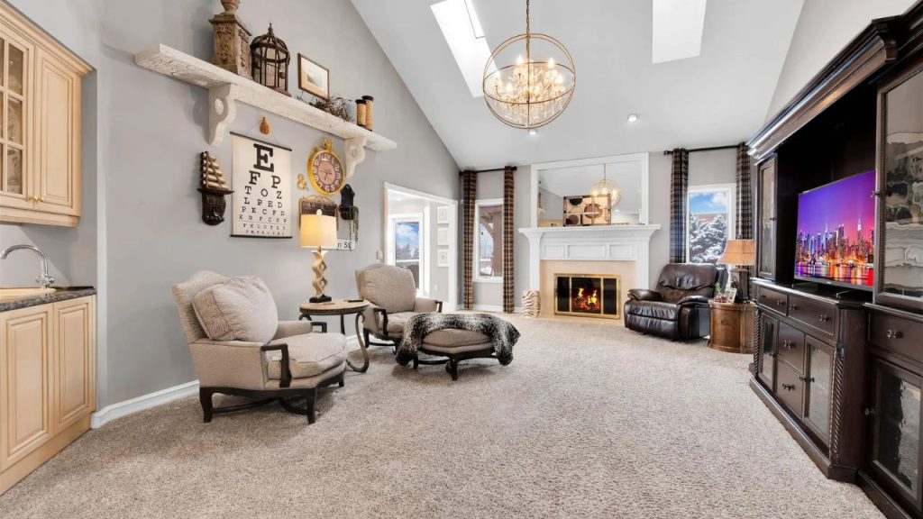 Spacious living room with vaulted ceilings, a fireplace, and cozy seating.