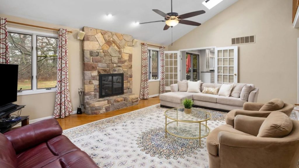Bright Living Room with Stone Fireplace