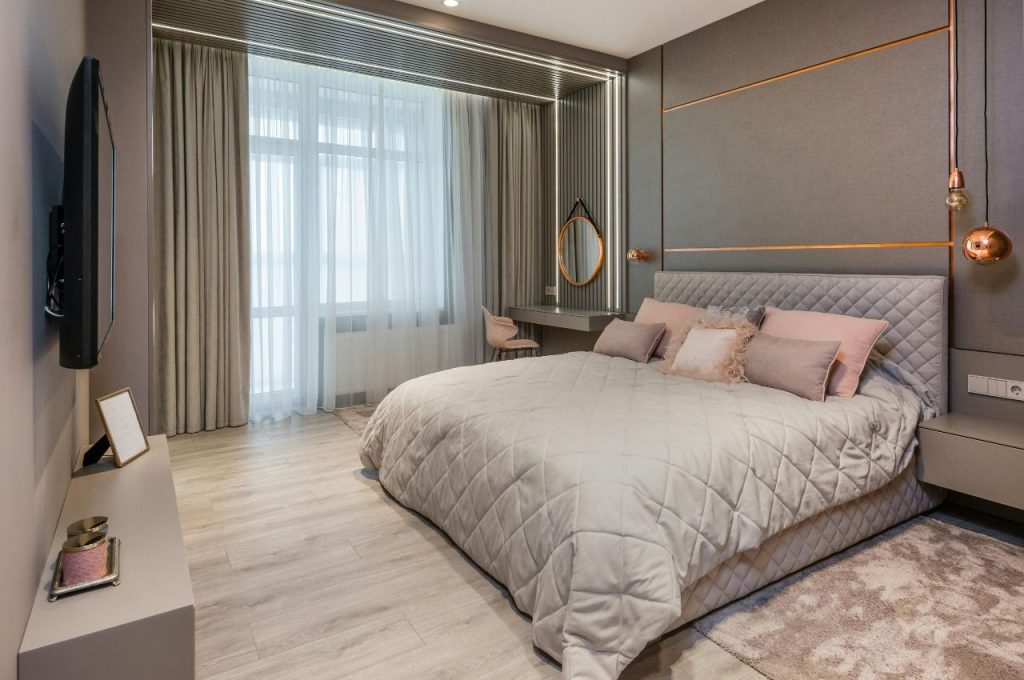 Luxury bedroom with tall curtains.